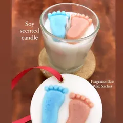 Here's a cute baby shower return favor combo. It includes a soy scented candle with baby feet toppers and a matching wax sachet that can be used as a fragrance bar for closets.