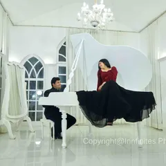 A classic and elegant pre-wedding portrait featuring our white grand piano, with the bride-to-be seated atop for a touch of glamour.
