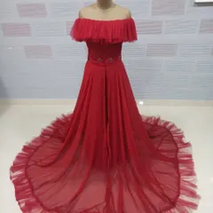 Our off-shoulder red gown offers a soft, romantic alternative for your photoshoot. The ruffled tulle trail adds texture and flows beautifully in photos.