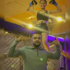 Victory. Celebrating a win with my student inside the MMA cage.
