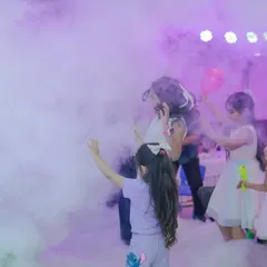 Kids playing in the harmless, dense fog created during the Mad Science show. It's a multi-sensory experience they will never forget.