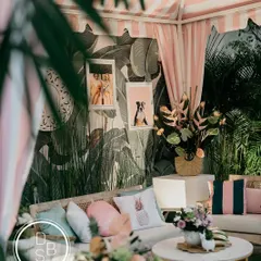 A glimpse into the cozy and stylish lounge area we created. The mix of tropical wallpaper, plush cushions, and personal photos made this corner feel like a chic Californian escape.