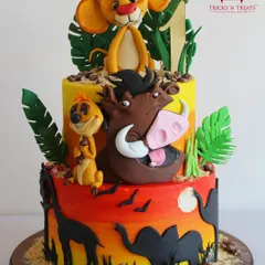 Hakuna Matata! This vibrant, two-tiered Lion King cake is a celebration of color and character. We teach you how to create a sunset airbrush effect and model beloved characters like Simba, Timon, and Pumbaa.
