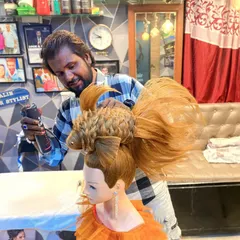Here I am, putting the finishing touches on the fish hairstyle with hairspray. This shows the precision and control needed to create such a detailed and imaginative design.