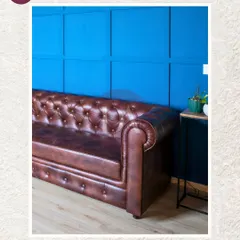 A closer look at the classic brown leather Chesterfield sofa. The deep button-tufting and rolled arms are timeless details that add a touch of sophistication to any space.