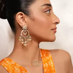 Diwali is incomplete without the sparkle of chandbaalis. This pair features intricate polki work and delicate pearl drops, designed to be a timeless addition to your festive wardrobe.
