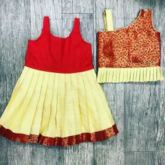 I can stitch these traditional outfits for very young babies. These two sets, designed for a six-month-old, show different top styles you can choose for your baby's first ethnic outfit.