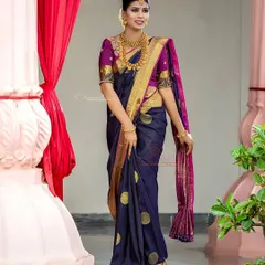 This classic navy blue and magenta silk saree is a timeless piece available for rent. The rich gold border and traditional motifs make it perfect for a wedding ceremony.