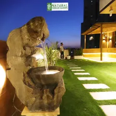 A unique rustic water feature installed at our Gwal Pahari project, crafted from natural wood to add a soothing, organic element to the garden.