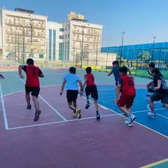 Players running laps as part of their warm-up, building cardiovascular fitness.