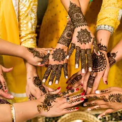 A beautiful photo showcasing the intricate and matching mehndi designs of the bride and her bridesmaids. This shot captures the spirit of friendship and shared celebration.
