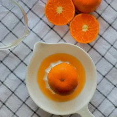 The process of creating my orange-flavored cakes begins with juicing fresh oranges by hand to ensure the most authentic and vibrant taste.
