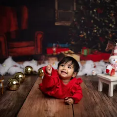 This little one is reaching for the stars, or maybe just a Christmas ornament. A lovely candid moment from the holiday shoot.