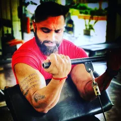 Focused on a preacher curl. This exercise is excellent for isolating the biceps to build peak and size, a key part of my muscle-building programs.