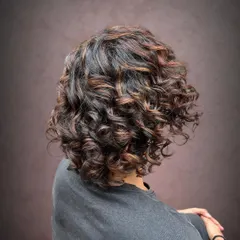 A side view showing how the pintura highlights accentuate her curls.