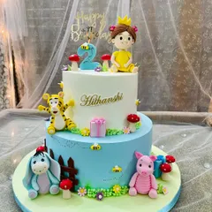 A whimsical two-tier cake for a little one's 2nd birthday, featuring friends from the Hundred Acre Wood. We handcrafted Tigger, Eeyore, and Piglet to create a sweet and playful scene.