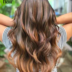 We call this one glitter and honey. This non-bleach balayage adds warm, coppery-gold dimension to a dark base, creating a beautiful glow, especially on long, wavy hair.