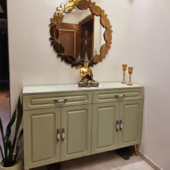 Storage can be beautiful. I designed this elegant console unit in a sage green PU finish to discreetly hide shoes, keeping the entryway organized and stylish for my client, Mrs. Rachana Agarwal.