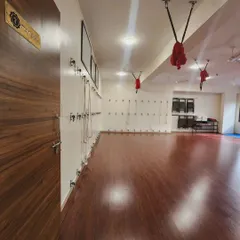 A look inside our Manipura studio, your sanctuary for mind, body, and spirit. The wall is lined with ropes and props, ready to support and enhance your practice, while the warm wooden floors provide a grounding foundation for your movement.