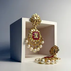 Where elegance meets heritage. These statement Kundan and pearl earrings are crafted with a ruby center to make every moment feel royal.