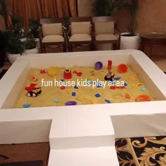 A close-up of the sandpit filled with 100% kinetic sand and a variety of colorful toys, ready for a sensory adventure.