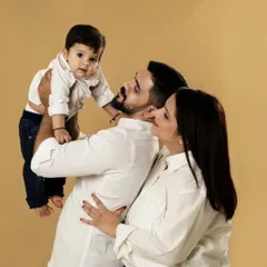 A playful moment between parents and their baby. We love capturing these candid interactions that show the fun and love in your family.