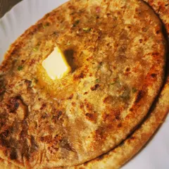 The perfect bite of Aloo Paratha, golden brown and filled with a delicious potato mixture.