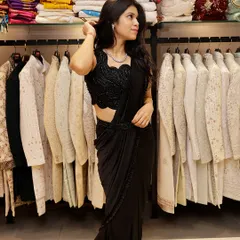 This is a full-length view of the black pre-draped saree. The outfit combines the grace of a traditional saree with the comfort and style of a modern gown.
