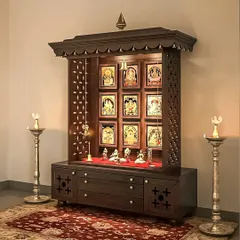 A traditional freestanding pooja mandir made of dark wood with intricate carvings and a backlight. This classic design brings a sense of sanctity to the home.