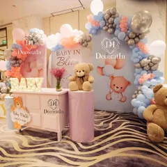 A dreamy "Baby in Bloom" baby shower setup. This beautiful arrangement uses soft pink, blue, and silver balloons, adorable teddy bear props, and custom backdrops to create a sweet and elegant celebration.