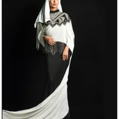 This full-length view displays the dramatic sweep of the gown's white train. It's a classic pose that emphasizes the garment's silhouette and elegant design, ideal for a designer's collection showcase.