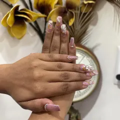 This close up shows the intricate details our nail artists can create. Each nail is a small piece of art, designed to add an extra layer of glamour to your look.