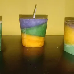A set of three handmade candles with different colored layers. These show the variety of color combinations I can create for a vibrant, multi-color decoration theme.
