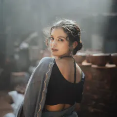 I love playing with light and shadow to create moody, evocative portraits. This shot, taken in a rustic setting, uses the soft, diffused light to highlight the model's expression as she looks back, creating a sense of story and intrigue.