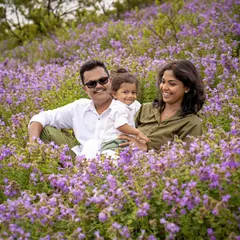 Another beautiful shot from the Neelakurinji flower fields. The family is sitting together, surrounded by a sea of purple, creating a truly magical and colorful portrait.