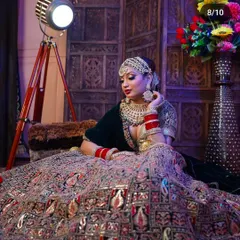A breathtaking shot of a bride in a multi-colored, heavily embroidered lehenga. The wide flare of the skirt shows the grandeur of the outfit, perfect for a royal bridal entry.