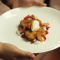 Bacon Pain Perdu. This is a savory and sweet dessert of brioche French toast with bacon bits, whipped crème fraîche, stone fruits, and elderflower ice cream.
