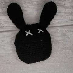 This crochet AirPods case is inspired by a spooky-cute bunny design. The black case features long ears and white "X" eyes for a bit of an edge.