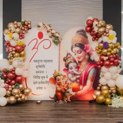 For this special baby shower, we blended tradition with modern decor. The backdrop features a beautiful illustration of Maa Parvati with baby Ganesha, framed by a rich maroon and gold balloon garland to give it a divine and celebratory feel.