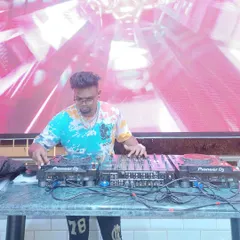 At the controls with a large LED screen backdrop. I am comfortable performing on big stages for corporate events and launches, providing both audio and visual excitement.