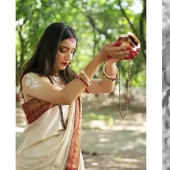 An offering of peace and devotion. The model, portraying Parvati, makes a water offering from a traditional copper pot, set against a serene forest backdrop.