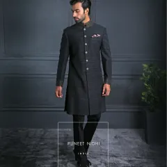 An ash grey Achkan in pure Matka silk, tailored with a clean straight cut and adorned with a jeweled mandarin collar. The textured weave reflects quiet strength and refined luxury.