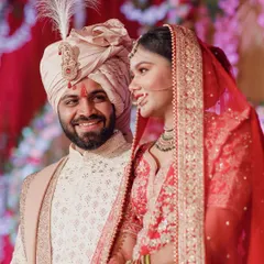 A candid, happy moment between the bride and groom on their wedding stage. Their joyful smiles and loving glance perfectly capture the happiness of their union.