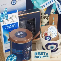 To protect the bond that protects you, I designed this 'Shielded in Blue' Rakhi hamper. It features an evil eye theme for good luck, combining premium chocolates, gourmet popcorn, and a men's grooming kit, all in sophisticated shades of navy blue.