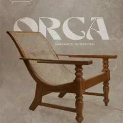 The 'Orca' lounge chair is designed for ultimate relaxation. Its low-slung, reclined frame is crafted from solid teak with turned legs, while the expansive rattan seat and back provide firm, breathable support.