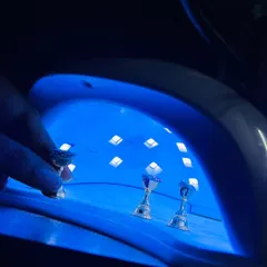 Curing the gel polish is a crucial step to ensure your press-on nails are strong, durable, and have a long-lasting shine. Each layer is cured under a UV lamp.