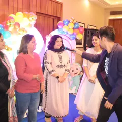 Interacting with guests during a birthday party. I love to move around the room and make sure everyone feels included in the festivities.