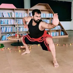 Our Kalari master Moideen Rafi holding a classic defensive posture. This stance is fundamental for developing a strong base and core, essential for both attack and defense.