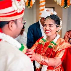 A candid moment of pure happiness between the bride and groom during their Maharashtrian wedding ceremony. We focus on capturing these genuine smiles and interactions that tell the real story of the day.
