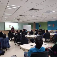 Here I am leading a training session in a corporate office. I create a comfortable environment where teams can learn about the nuances of professional etiquette, from meeting conduct to email communication.